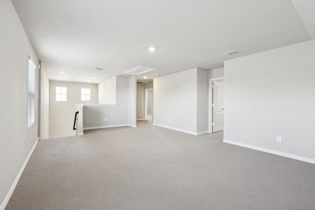 interior space with carpet flooring, attic access, recessed lighting, baseboards, and visible vents