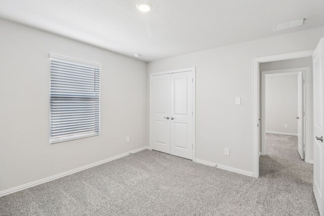 607 Willet Dr, Mckinney, TX 75069 - unfurnished bedroom with baseboards, light colored carpet, visible vents, and a closet