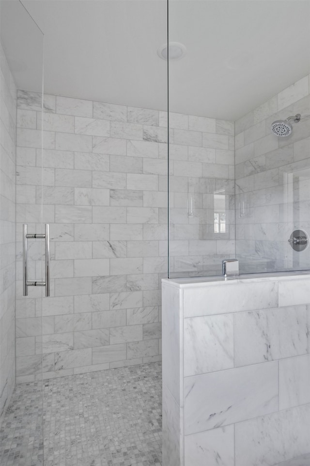 bathroom with tiled shower