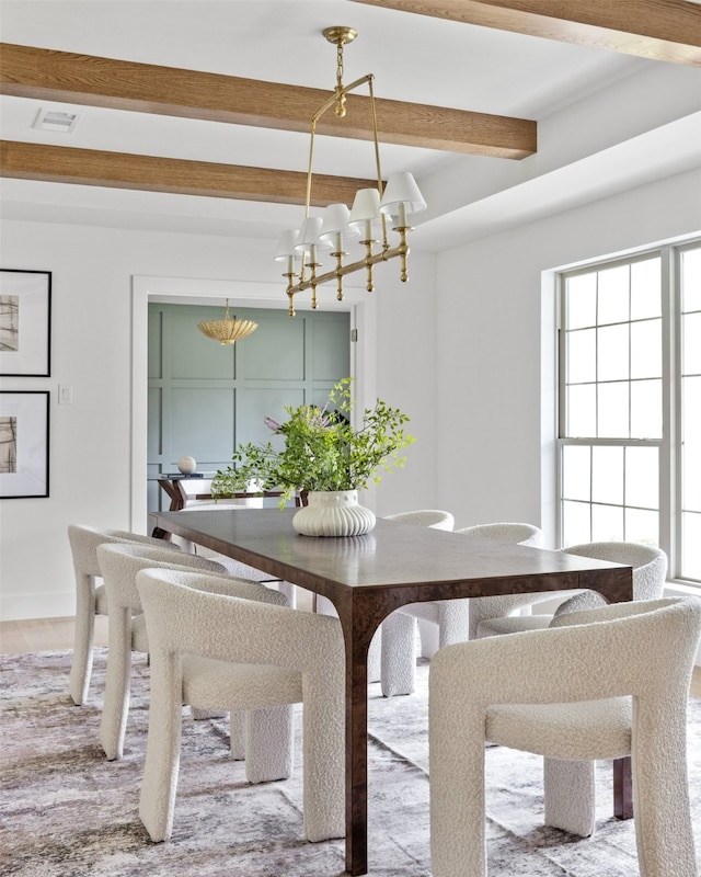 dining room with beamed ceiling, a chandelier, plenty of natural light, and visible vents