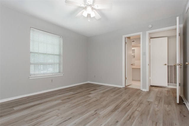 6007 Sandhurst Ln Unit B, Dallas, TX 75206 - unfurnished bedroom with light wood-style floors, baseboards, ceiling fan, and ensuite bath