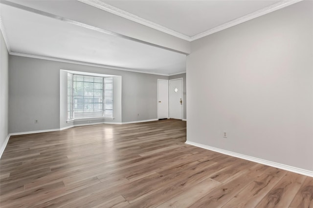 6007 Sandhurst Ln Unit B, Dallas, TX 75206 - empty room with crown molding, baseboards, and wood finished floors
