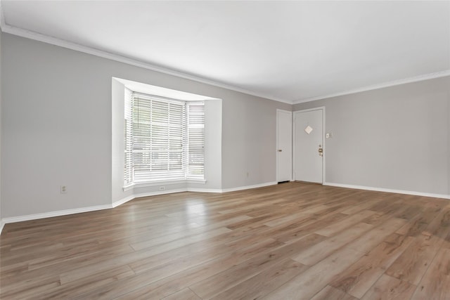 6007 Sandhurst Ln Unit B, Dallas, TX 75206 - unfurnished living room with baseboards, ornamental molding, and light wood finished floors
