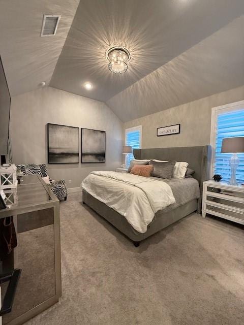 carpeted bedroom with visible vents and lofted ceiling