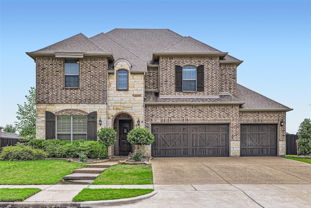 french country inspired facade featuring stone siding, brick siding, a shingled roof, an attached garage, and driveway