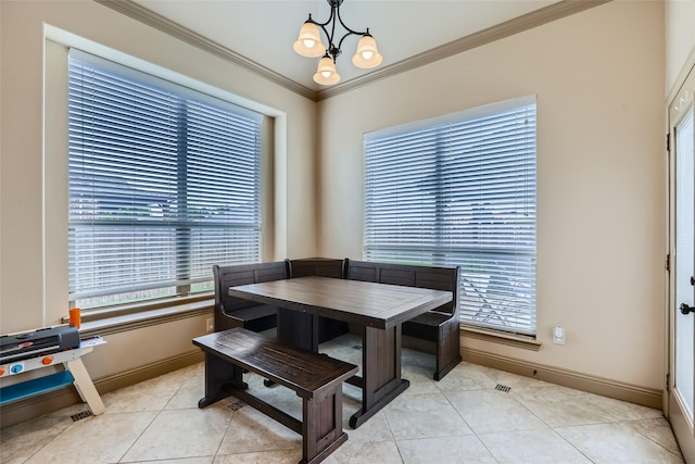 dining space featuring crown molding, baseboards, and a healthy amount of sunlight
