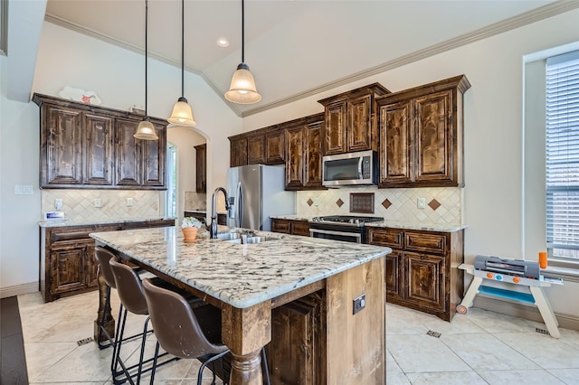 kitchen featuring dark brown cabinetry, appliances with stainless steel finishes, ornamental molding, and a sink