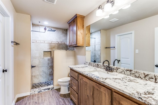 140 Tnt Ct, Springtown, TX 76082 - bathroom featuring walk in shower, vanity, toilet, baseboards, and wood finished floors