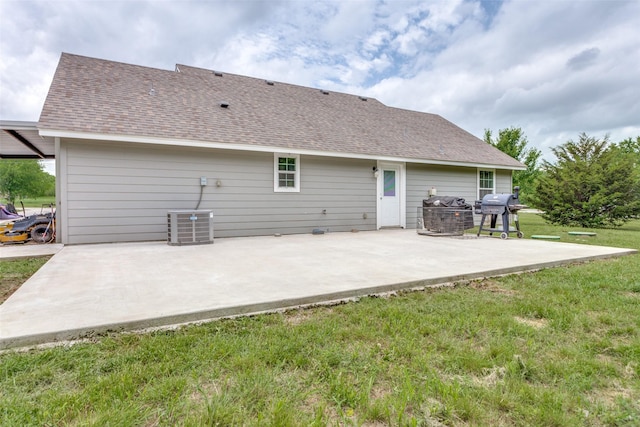 140 Tnt Ct, Springtown, TX 76082 - rear view of house with a lawn, a shingled roof, a patio area, and central AC