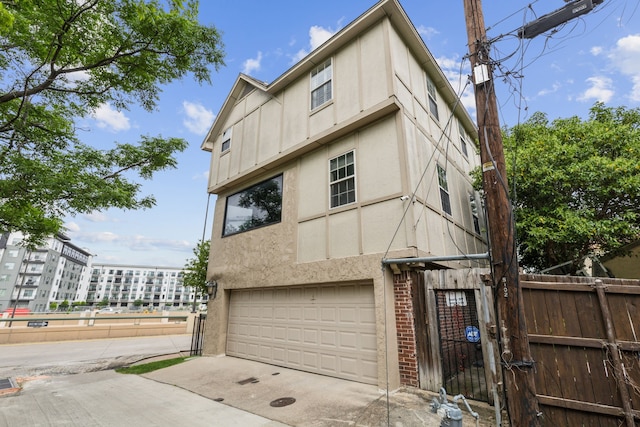 5102 Ridgedale Ave, Dallas, TX 75206 - view of front facade with a garage, stucco siding, a gate, and driveway