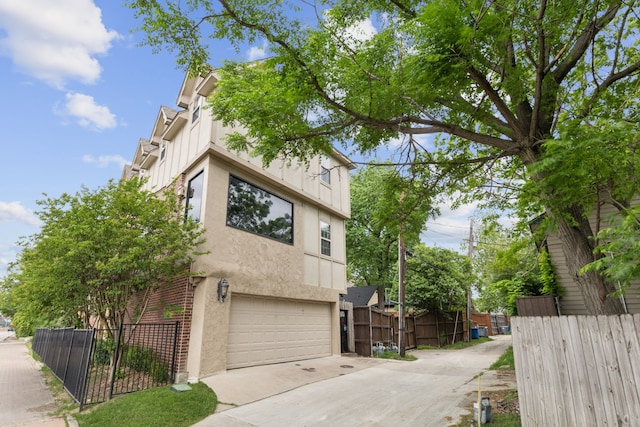 5102 Ridgedale Ave, Dallas, TX 75206 - view of home's exterior with stucco siding, a garage, and driveway