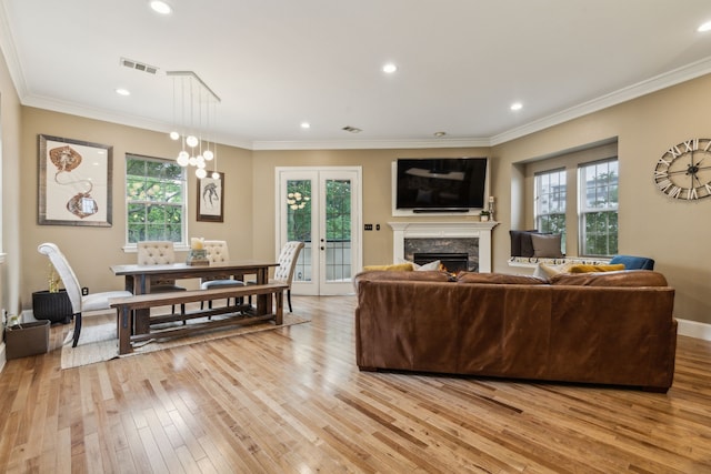 5102 Ridgedale Ave, Dallas, TX 75206 - living room featuring a warm lit fireplace, light wood-style flooring, healthy amount of natural light, crown molding, and recessed lighting