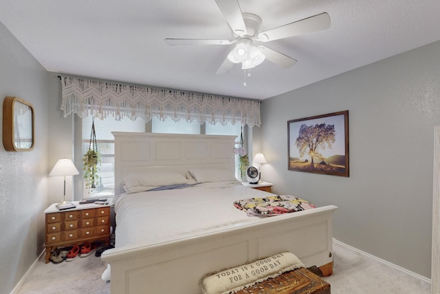 bedroom featuring baseboards, multiple windows, and light carpet
