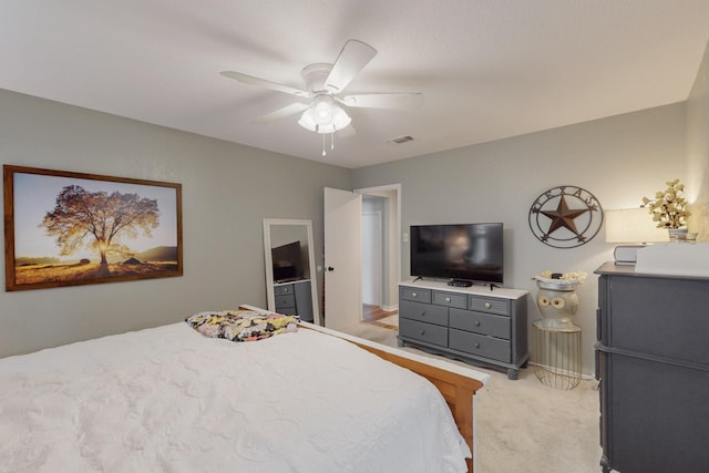 bedroom with ceiling fan, light carpet, and visible vents