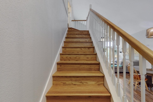 stairs featuring a textured wall