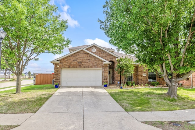 view of front of property featuring a garage, a front yard, brick siding, a shingled roof, and driveway