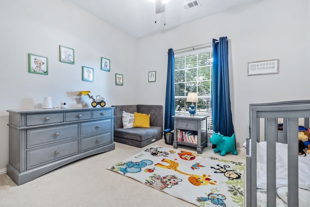 carpeted bedroom with ceiling fan and visible vents