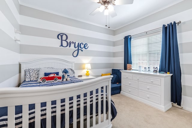 bedroom featuring ceiling fan and light carpet
