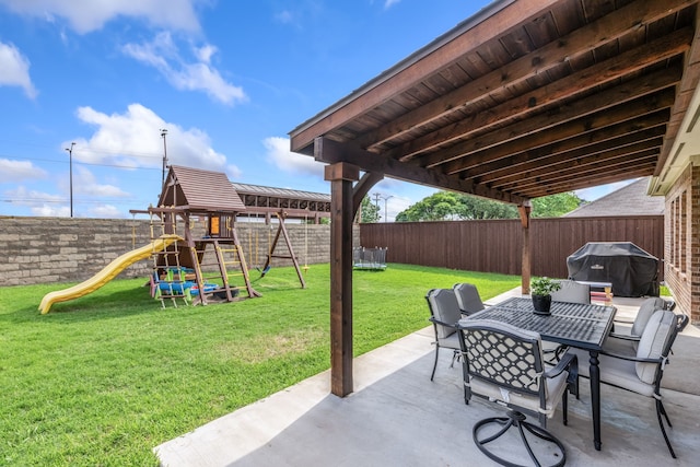 view of patio featuring a playground, grilling area, outdoor dining area, and a fenced backyard