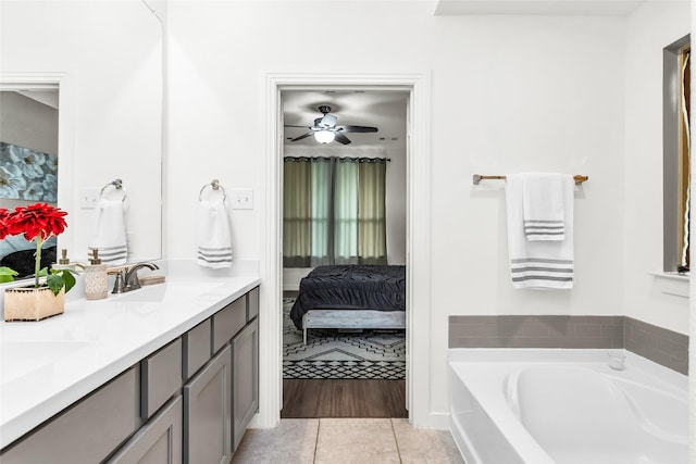 full bathroom with a sink, tile patterned floors, ensuite bath, and a bath