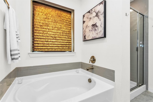 full bath featuring a garden tub and a stall shower