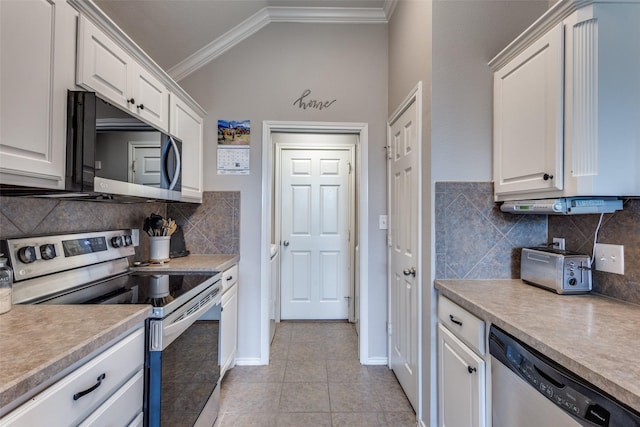 kitchen with crown molding, appliances with stainless steel finishes, vaulted ceiling, white cabinets, and light tile patterned flooring