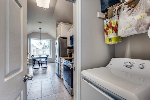 laundry area with laundry area, washer / clothes dryer, visible vents, light tile patterned floors, and a chandelier