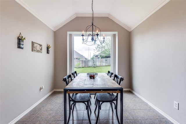 dining room with baseboards, ornamental molding, vaulted ceiling, and a notable chandelier