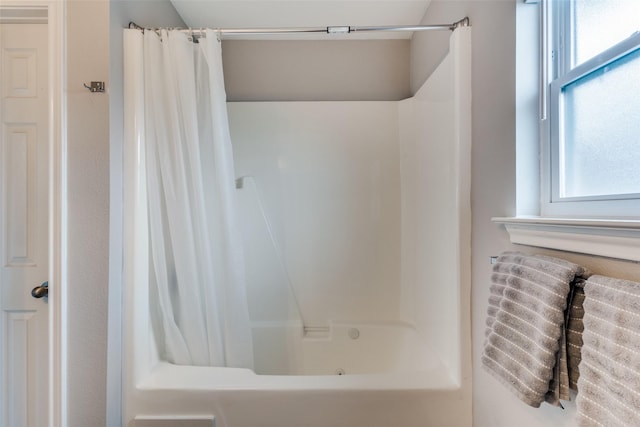 bathroom featuring shower / bath combo with shower curtain and a wealth of natural light