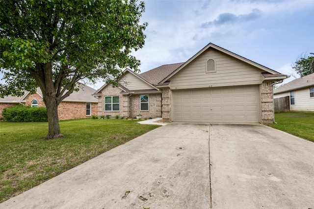 ranch-style home featuring an attached garage, concrete driveway, a front yard, and brick siding