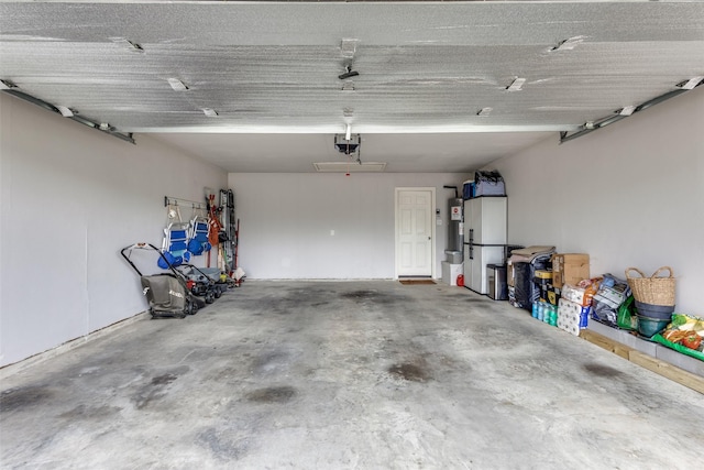 garage with water heater and a garage door opener