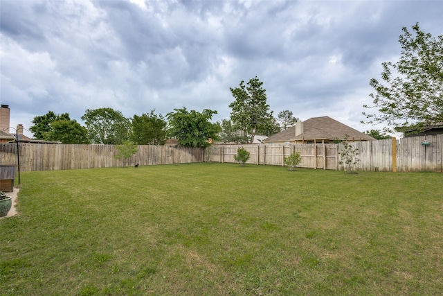view of yard with a fenced backyard
