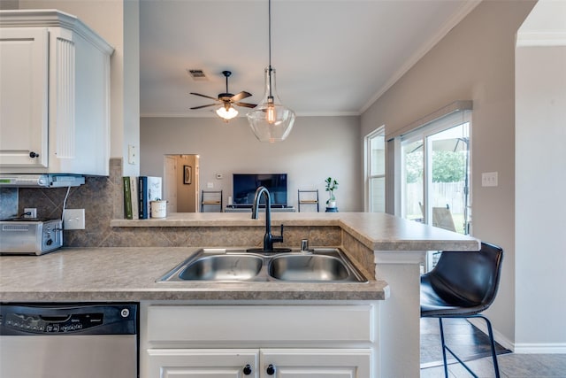 kitchen with visible vents, ornamental molding, a sink, and dishwasher