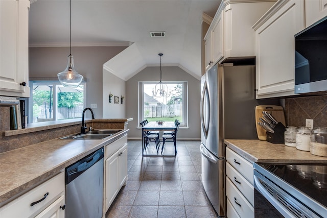 kitchen featuring appliances with stainless steel finishes, a wealth of natural light, a sink, and visible vents