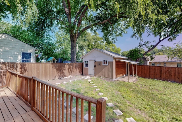 exterior space featuring an outdoor structure, a fenced backyard, and a deck