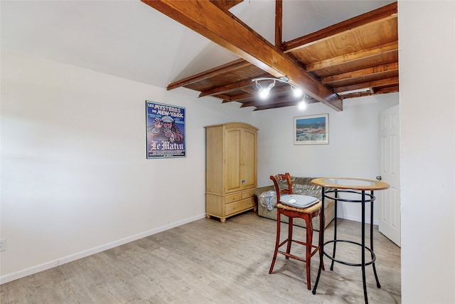 dining area with baseboards, light wood-style floors, beam ceiling, and wooden ceiling