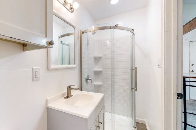 bathroom featuring vanity and a shower stall