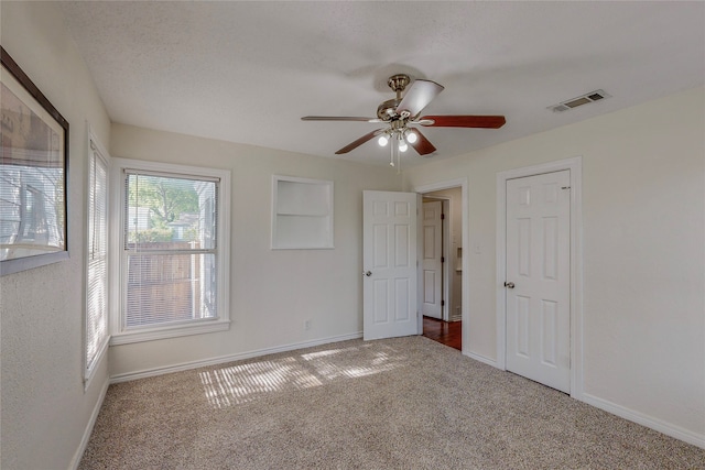 unfurnished bedroom with baseboards, carpet flooring, and visible vents