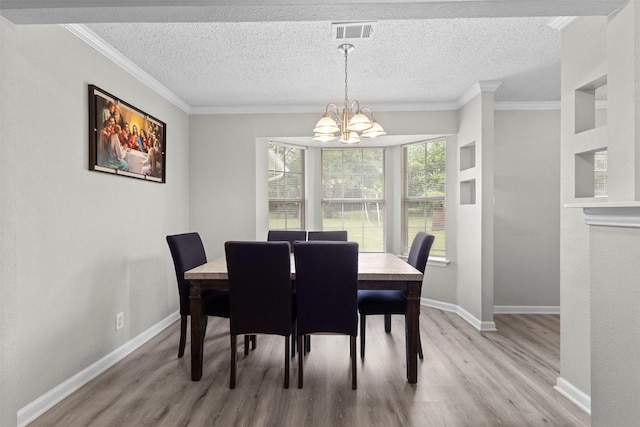 dining area featuring baseboards, a chandelier, and light wood finished floors