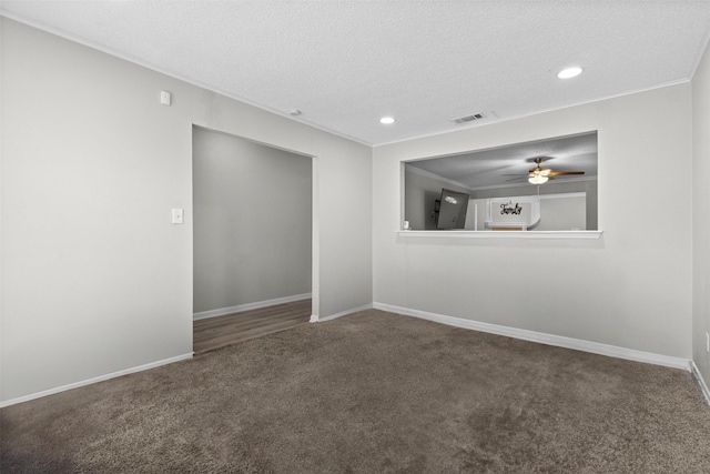 empty room featuring a ceiling fan, a textured ceiling, visible vents, baseboards, and carpet flooring