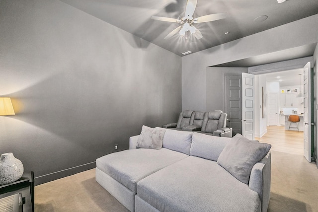 interior space with baseboards, light carpet, and a ceiling fan