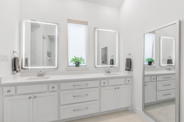 full bath featuring a sink, double vanity, and marble finish floor