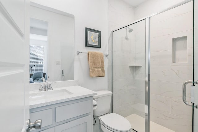 ensuite bathroom featuring vanity, ensuite bath, a stall shower, and toilet