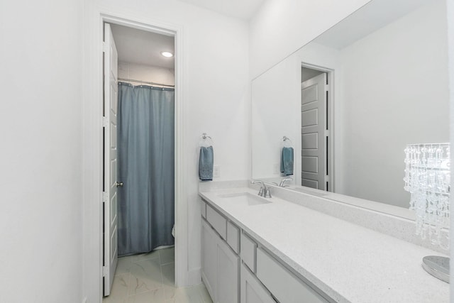 bathroom featuring vanity, marble finish floor, and toilet