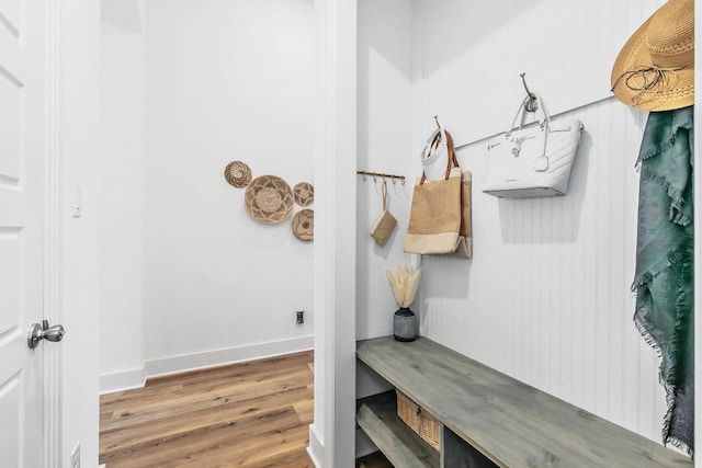mudroom featuring baseboards and wood finished floors