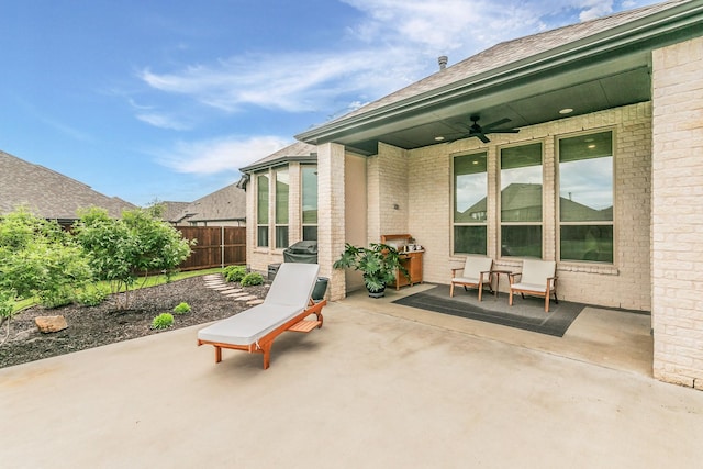 view of patio / terrace featuring fence and a ceiling fan