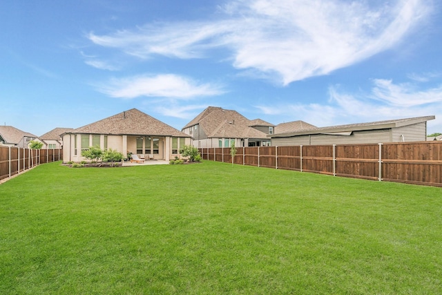 view of yard with a fenced backyard and a patio