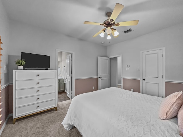 bedroom with connected bathroom, carpet, a ceiling fan, baseboards, and visible vents