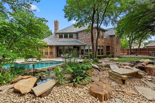 outdoor pool featuring fence and a patio area