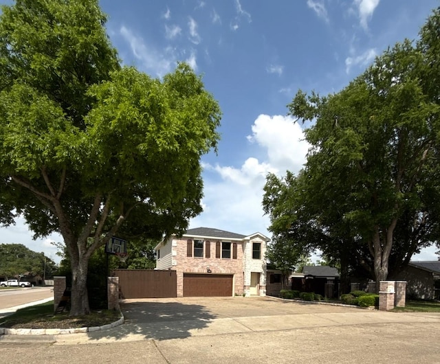 view of front of home with an attached garage, stone siding, and concrete driveway